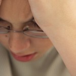 Stressed Schoolboy with Head in Hands