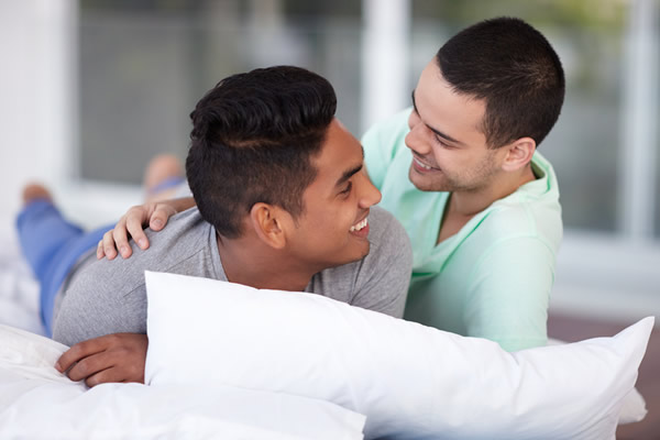 young happy gay couple relaxing, gay news, Washington Blade