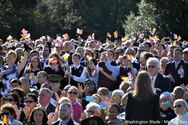 Onlookers waive flags as Pope Francis II visits the White House. (Blade photo by Michael Key)