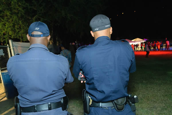 Two police officers stand outside a Pride party in Kingston, Jamaica, on Aug. 5, 2015. Consensual same-sex sexual relations remain criminalized in the country, but LGBT rights advocates have become more visible in recent years in spite of persistent violence and discrimination. (Photo courtesy of J-FLAG)