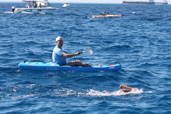 Marty Filipowski crossing the Rottnest Channel with his husband, Sonny, paddling alongside him. (Photo courtesy Filipowski)