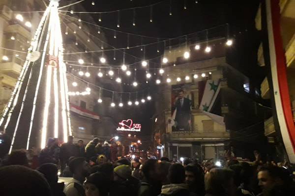 Supporters of Syrian President Bashar Assad celebrate his army's recapture of the city of Aleppo on Dec. 22, 2016. (Photo submitted)